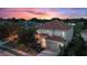 Two-story house with tile roof, and a two-car garage at sunset at 5204 Oakbourne Ave, Davenport, FL 33837