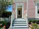 Front entrance with stairs, white railings, and landscaping at 713 Mulberry Ave, Celebration, FL 34747