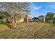 Large backyard with a screened porch and mature trees at 4319 Dinner Lake Blvd, Lake Wales, FL 33859