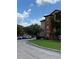 Exterior view of an apartment building with parking and landscaping at 5500 Metrowest Blvd # 304, Orlando, FL 32811