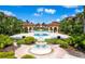 Community pool with fountain, pavilions, and lush landscaping at 5500 Metrowest Blvd # 304, Orlando, FL 32811