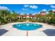 Resort-style pool with surrounding patio and landscaping at 5500 Metrowest Blvd # 304, Orlando, FL 32811