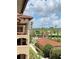 View from balcony showing a walkway, landscaping, and building exterior at 5500 Metrowest Blvd # 304, Orlando, FL 32811