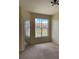 Bright bedroom with mirrored closet doors and a large window offering a view at 5500 Metrowest Blvd # 304, Orlando, FL 32811