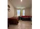 Cozy bedroom with twin bed and sofa, carpeted floor at 2590 Cliff Way, Saint Cloud, FL 34771