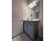 Single vanity bathroom with gray cabinets and a large mirror at 2590 Cliff Way, Saint Cloud, FL 34771