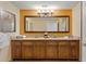Double vanity bathroom with large mirror and walk-in shower at 12544 Floridays Resort Dr # 503-B, Orlando, FL 32821