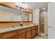 Bathroom with double vanity, large mirror, and shower at 12544 Floridays Resort Dr # 503-B, Orlando, FL 32821