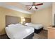 Bedroom with two double beds and ceiling fan at 12544 Floridays Resort Dr # 503-B, Orlando, FL 32821