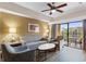 Living room with comfortable seating and access to balcony at 12544 Floridays Resort Dr # 503-B, Orlando, FL 32821