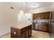 Island kitchen with granite countertops and wood cabinets at 12544 Floridays Resort Dr # 503-B, Orlando, FL 32821