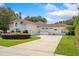 House with tile roof, large driveway, and lush landscaping at 1912 Belford Ct, Maitland, FL 32751