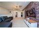 Spacious living area with a comfortable couch and a brick feature wall at 4611 Terrasonesta Dr, Davenport, FL 33837