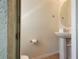 Small, well-lit bathroom with pedestal sink and toilet at 4611 Terrasonesta Dr, Davenport, FL 33837