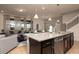 Modern kitchen island with granite countertops and stainless steel dishwasher at 4611 Terrasonesta Dr, Davenport, FL 33837