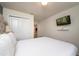Bright bedroom with a comfy bed, TV, and double doors leading to another room at 4611 Terrasonesta Dr, Davenport, FL 33837