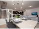 Elegant dining room with a modern table, place settings, and a statement chandelier at 4611 Terrasonesta Dr, Davenport, FL 33837