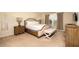 Charming bedroom with a wooden bed frame, nightstands, and a bench at 4611 Terrasonesta Dr, Davenport, FL 33837