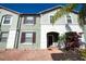 Green two-story townhome with dark shutters at 4611 Terrasonesta Dr, Davenport, FL 33837