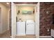 Convenient laundry closet with washer, dryer, and built-in shelving at 4611 Terrasonesta Dr, Davenport, FL 33837