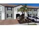 Two-story townhome with a brick paved driveway at 4611 Terrasonesta Dr, Davenport, FL 33837