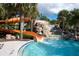 Orange water slide leading into a refreshing pool at 4611 Terrasonesta Dr, Davenport, FL 33837