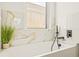 Bathroom with a bathtub and marble tile surround at 6368 Chorus Dr, Mascotte, FL 34753