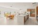Open concept kitchen with island and dining area at 6368 Chorus Dr, Mascotte, FL 34753