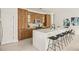Modern kitchen with wood cabinets and large island at 6368 Chorus Dr, Mascotte, FL 34753