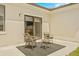 Relaxing patio with two wicker chairs and a small side table at 6368 Chorus Dr, Mascotte, FL 34753
