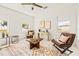 Bright sitting room with two leather chairs and a wooden coffee table at 6368 Chorus Dr, Mascotte, FL 34753