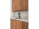 Modern wet bar with wood cabinets and a white countertop at 6368 Chorus Dr, Mascotte, FL 34753