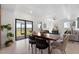 Open concept dining area with modern table and access to backyard at 6422 Chorus Dr, Mascotte, FL 34753