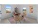 Home office with a desk, two chairs, and a large window overlooking the street at 6422 Chorus Dr, Mascotte, FL 34753