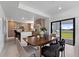 Modern kitchen with island, stainless steel appliances, and dining area at 6422 Chorus Dr, Mascotte, FL 34753