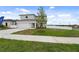 Two-story house with attached garage, viewed from the side at 6422 Chorus Dr, Mascotte, FL 34753