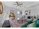 Cozy living room with a comfortable sofa and armchairs, and a large window at 6422 Chorus Dr, Mascotte, FL 34753