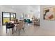 Modern dining area with a wooden table and chairs, near sliding glass doors at 6422 Chorus Dr, Mascotte, FL 34753