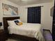 Spacious bedroom with a queen bed and dark wood furniture at 2805 Avenue M Nw, Winter Haven, FL 33881