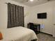 Bright bedroom with a double bed, desk, and TV at 2805 Avenue M Nw, Winter Haven, FL 33881
