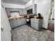 Modern kitchen with gray cabinets, stainless steel appliances, and wood countertops at 2805 Avenue M Nw, Winter Haven, FL 33881