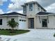 Modern two-story house with attached garage at 134 Blazing Star Ave, Lake Alfred, FL 33850