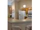 Functional kitchen with light wood cabinets and a breakfast bar at 1124 Chateau Cir, Minneola, FL 34715