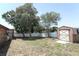 Yard with mature trees, shed, and privacy fence at 2037 Apricot Dr, Deltona, FL 32725