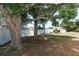 Landscaped backyard with large trees and shed at 2037 Apricot Dr, Deltona, FL 32725