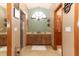 Bathroom with double vanity, shower, and wood cabinets at 2037 Apricot Dr, Deltona, FL 32725