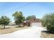 Brick house with a two-car garage and solar panels on the roof at 2037 Apricot Dr, Deltona, FL 32725