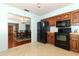 Kitchen with a view into the dining area and wood cabinets at 2037 Apricot Dr, Deltona, FL 32725