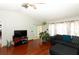 Living room with hardwood floors, sectional sofa and large TV at 2037 Apricot Dr, Deltona, FL 32725