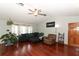 Spacious living room with hardwood floors, sectional sofa and ceiling fan at 2037 Apricot Dr, Deltona, FL 32725
